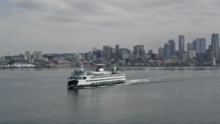 AX45_025E - 5K aerial stock footage ferry sailing Elliott Bay, reveal the Space Needle and Downtown Seattle, Washington