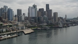 AX45_030E - 5K aerial stock footage of Downtown Seattle skyline and Central Waterfront seen from Elliott Bay, Washington