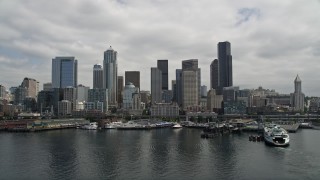 AX45_034E - 5K aerial stock footage flying by the skyline and Seattle Great Wheel on Pier 57, Downtown Seattle, Washington