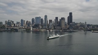 AX45_040E - 5K stock footage aerial video tilting from Elliott Bay to reveal Downtown Seattle skyline and ferry, Seattle, Washington