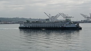 AX45_046 - 5K aerial stock footage flying beside a ferry sailing Elliott Bay, Seattle