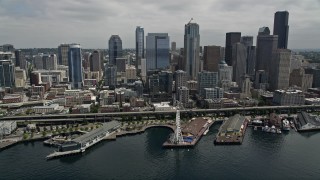 AX45_049 - 5K aerial stock footage approaching the skyline and Waterfront, and tilt down to the Great Wheel, Downtown Seattle, Washington