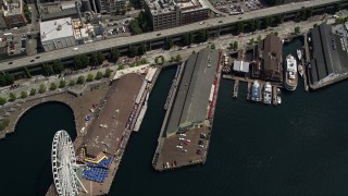 AX45_050 - 5K aerial stock footage tilting to bird's eye view of the Great Wheel, Pier 56, and Alaskan Way Viaduct in Downtown Seattle, Washington