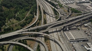 AX45_061 - 5K aerial stock footage flying by and tilting to light traffic on the I-5 and I-90 Express interchange, Greater Duwamish, Seattle, Washington