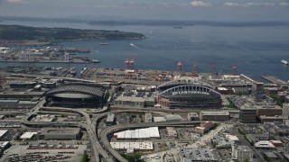 AX45_062 - 5K aerial stock footage flying by Safeco Field, Century Link Field, and Elliott Bay, Downtown Seattle, Washington
