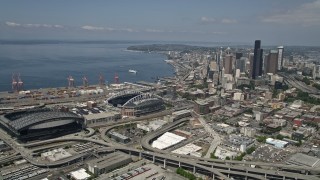 AX45_063 - 5K stock footage aerial video approaching Safeco and CenturyLink Fields, and pan toward skyscrapers in Downtown Seattle, Washington