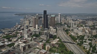 AX45_064E - 5K aerial stock footage tilting from light traffic on the I-5 Express to reveal skyscrapers in Downtown Seattle, Washington