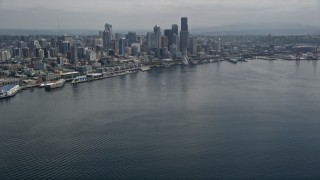 AX45_071 - 5K aerial stock footage tilting from Elliott Bay to reveal the skyline of Downtown Seattle, Washington