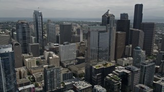 AX45_075 - 5K aerial stock footage flying over skyscrapers and high-rises to approach Rainier Tower, Downtown Seattle, Washington