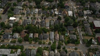 AX45_078 - 5K aerial stock footage flying over urban homes and reveal a high school, Central Seattle, Washington