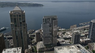 AX45_087E - 5K aerial stock footage flying over Russell Investments Center, tilt to Seattle Great Wheel on Central Waterfront, Downtown Seattle, Washington