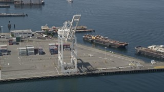 AX45_094 - 5K aerial stock footage approaching a cargo crane near shipping containers, Port of Seattle, Washington