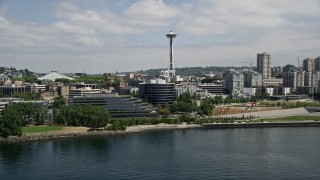 AX45_099E - 5K aerial stock footage flying by Waterfront piers and office buildings with Space Needle in background, Downtown Seattle, Washington