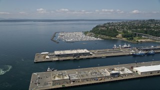 AX45_102E - 5K aerial stock footage approach warehouse buildings on Pier 90 and 91 near the marina, Smith Cove, Seattle, Washington