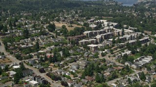 AX45_105 - 5K aerial stock footage flyby homes to approach apartment buildings, Magnolia, Seattle, Washington