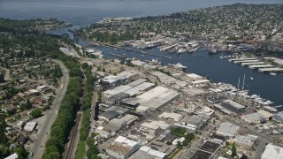 AX45_106E - 5K aerial stock footage fly over waterfront warehouses and pan to locks in the canal, Salmon Bay, Seattle, Washington