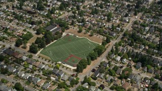AX45_110 - 5K aerial stock footage flyby a sports field in a suburban area, Ballard, Washington