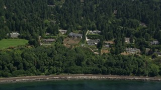 AX45_116 - 5K aerial stock footage of waterfront mansions and trees near the shore, Shoreline, Washington