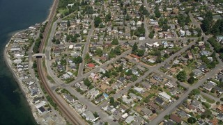 AX45_118 - 5K aerial stock footage approach train tracks and a waterfront community, Shoreline, Washington