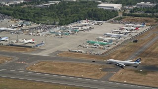 AX45_132 - Aerial stock footage of 5K aerial  video fly by parked airliners at Paine Field airport, Everett, Washington