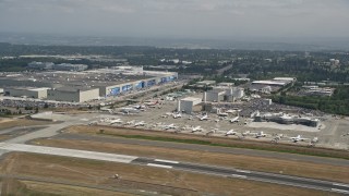 AX45_133 - 5K stock footage aerial video of airliners parked near the Boeing Factory at Paine Field airport, Everett, Washington