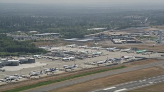 AX45_137 - 5K stock footage aerial video of passing by parked airliners at Paine Field, Everett, Washington