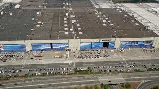 AX45_144 - 5K aerial stock footage approach the Boeing Everett Factory and tilt to the roof, Paine Field, Everett, Washington