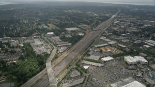 AX46_010 - 5K aerial stock footage flyby Interstate 5 with light traffic by shopping centers, Lynnwood, Washington