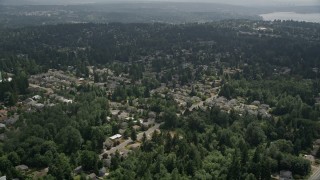 AX46_017E - 5K aerial stock footage flying over trees and suburban neighborhoods, Kenmore, Washington