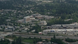 AX46_022 - Aerial stock footage of A view of Evergreen Hospital Medical Center and a strip mall, Kirkland, Washington