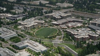 AX46_033 - 5K aerial stock footage flying by a soccer field by the Commons at Microsoft Headquarters campus, Redmond, Washington