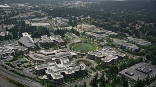 AX46_034E - 5K aerial stock footage orbiting office buildings around The Commons and a soccer field, Microsoft Headquarters, Redmond, Washington