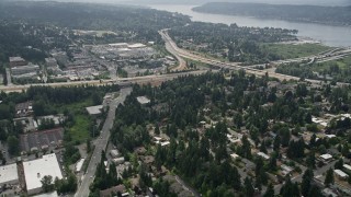 AX46_043 - 5K aerial stock footage tilt to suburban homes near a freeway interchange, Bellevue, Washington