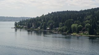 AX46_047 - 5K aerial stock footage of flying by lakeside homes with docks on Lake Washington, Mercer Island, Washington