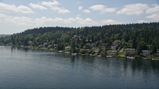 AX46_048 - 5K aerial stock footage of flying by lakeside homes with docks on the lake, Mercer Island, Washington