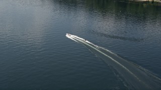 AX46_049 - 5K aerial stock footage track a speedboat pulling a raft on Lake Washington, Washington
