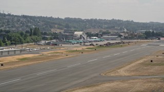 AX46_054 - 5K aerial stock footage of airliners parked at a small airport, Renton Municipal Airport, Washington