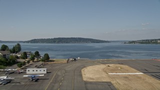AX47_001 - 5K aerial stock footage take off from Renton Municipal Airport and fly over Lake Washington toward Mercer Island, Washington
