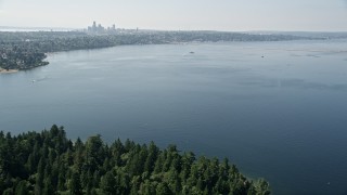 AX47_009 - 5K aerial stock footage fly over Lake Washington to approach bridge and the Downtown Seattle skyline in Washington