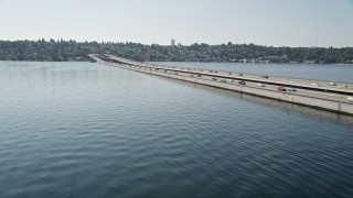 AX47_010E - 5K aerial stock footage flyby lakeside homes, bridge spanning Lake Washington, reveal downtown skyline, Mercer Island, Seattle, Washington