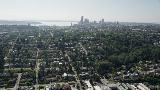 AX47_014 - 5K aerial stock footage of Downtown Seattle skyline seen from suburban neighborhoods by the shore of Lake Washington, Washington