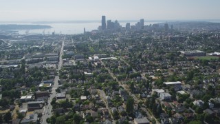 AX47_015 - 5K aerial stock footage tilt from park to reveal urban homes in Central Seattle and the Downtown Seattle skyline, Washington