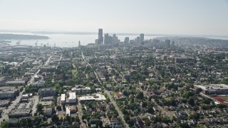 AX47_015E - 5K aerial stock footage tilt from park to reveal urban homes in Central Seattle and the Downtown Seattle skyline, Washington