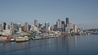 AX47_032 - 5K aerial stock footage of Downtown Seattle skyline and Central Waterfront piers seen from Elliott Bay, Washington