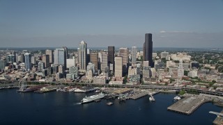 AX47_036E - 5K aerial stock footage approach Downtown Seattle skyline and fly over the Seattle Ferry Terminal on the Waterfront toward Central Seattle, Washington