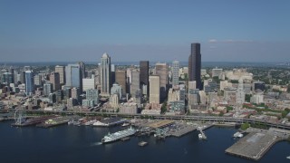 AX47_037 - 5K aerial stock footage approach Downtown Seattle skyline and fly over the Seattle Ferry Terminal on the Waterfront, Washington