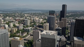 AX47_055E - 5K aerial stock footage fly over Downtown Seattle, and tilt to reveal an intersection beside the Seattle Public Library, Washington