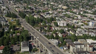 AX47_067 - 5K aerial stock footage fly over Lake Union to approach Aurora Bridge and light traffic crossing the span, Seattle, Washington
