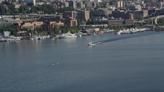 AX47_069E - 5K aerial stock footage of tracking a seaplane taking off from Lake Union, Seattle, Washington