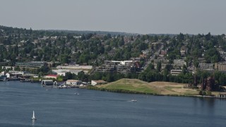 AX47_071 - 5K aerial stock footage of tracking a seaplane and revealing Fremont Cut, Queen Anne, Washington